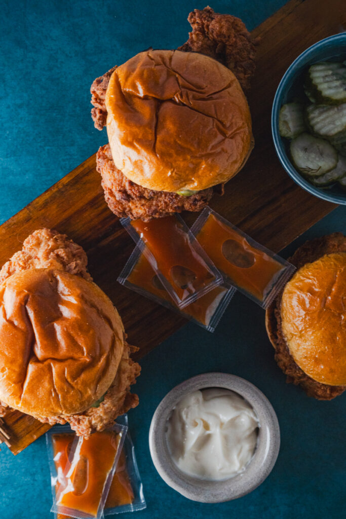Indulge in the comfort of your own kitchen with our copycat Chick-fil-A sandwich recipe. This image captures the essence of a classic favorite with its crispy, golden-brown chicken, shiny brioche buns, tangy pickles, and rich, creamy sauce. Perfect for a homemade fast-food experience!